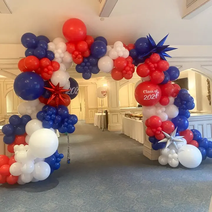 a bunch of balloons that are on the ground in a room with a blue carpet and a white ceiling