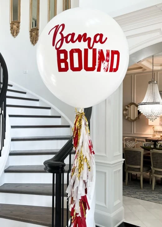 a white balloon with the words obama bound on it in front of a staircase with a red and white ribbon tied to it